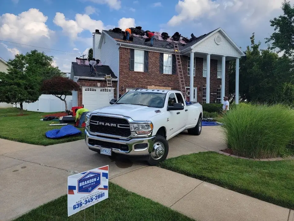 Brandon J Roofing project — roofing contractors working on residential house