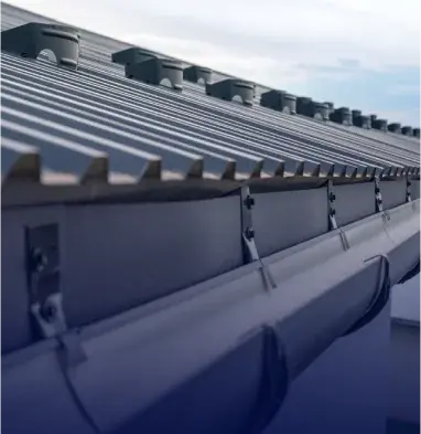 Newly installed seamless gutters protecting a residential home from water damage in St. Louis