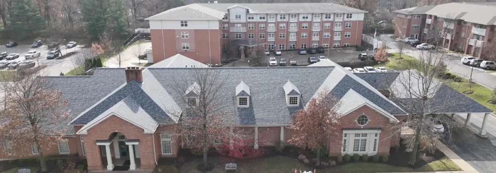 Aerial view of brick buildings and parking lot.