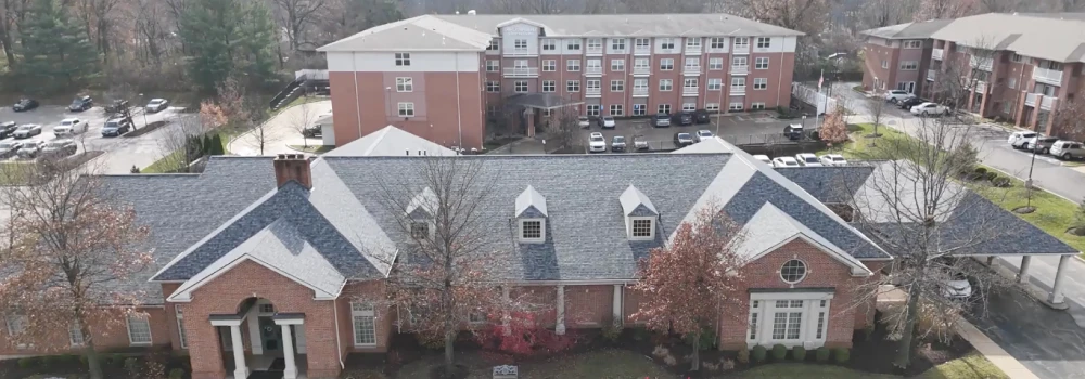 Aerial view of residential buildings and parking lot — after roof replacement