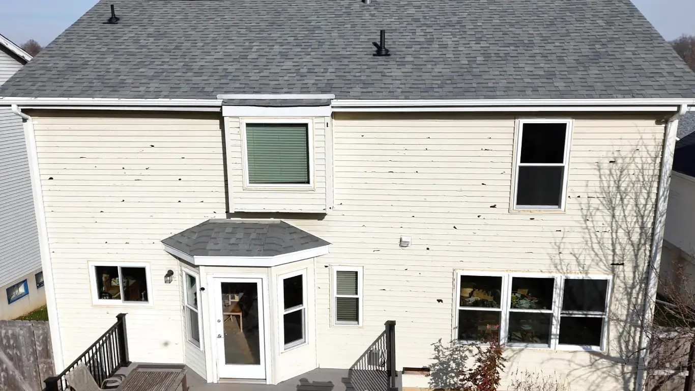 House exterior with visible damage on siding.
