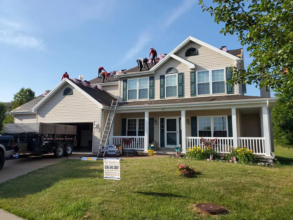 Roofers working on roofing shingles.