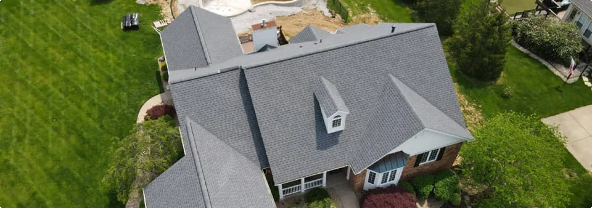 Aerial view of house with gray roof and yard in Wentzville, MO